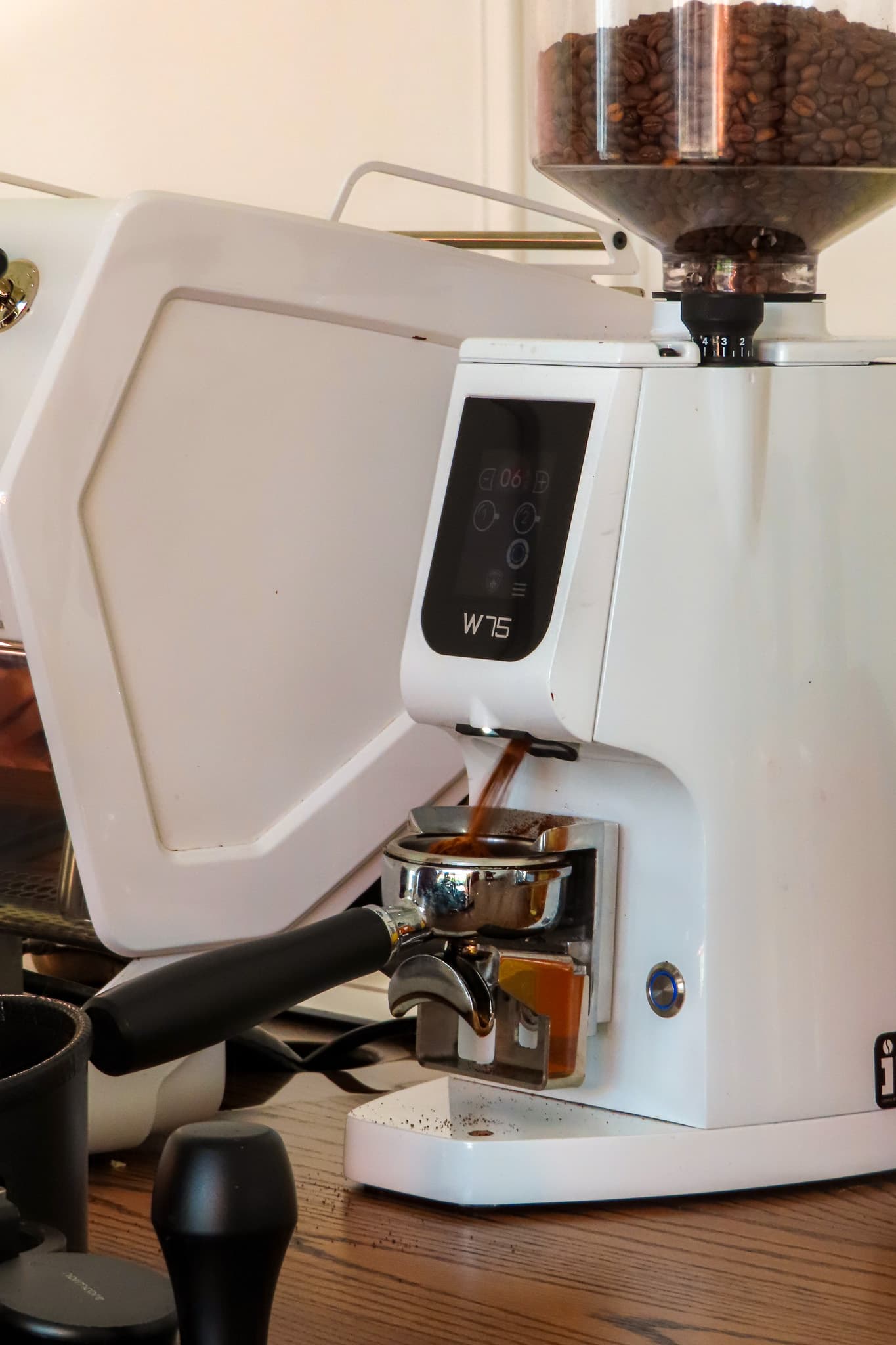 Espresso being ground into a portafilter on the Hilal Coffee cart